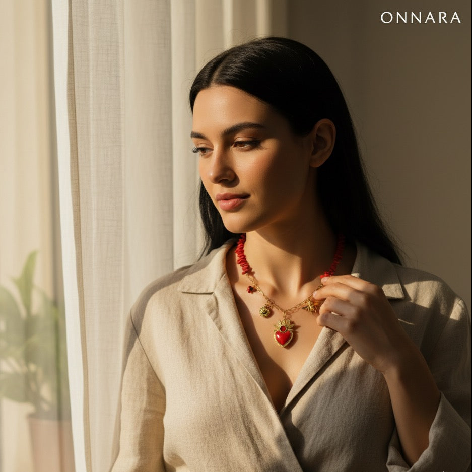 Woman wearing a necklace with a heart pendant in a softly lit room, featuring the ONNARA brand.