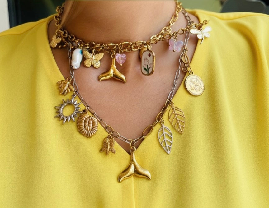 Gold charm necklace on a yellow background Onnara charm bar 